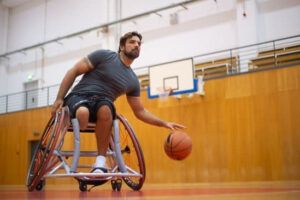A man plays basketball in a wheelchair